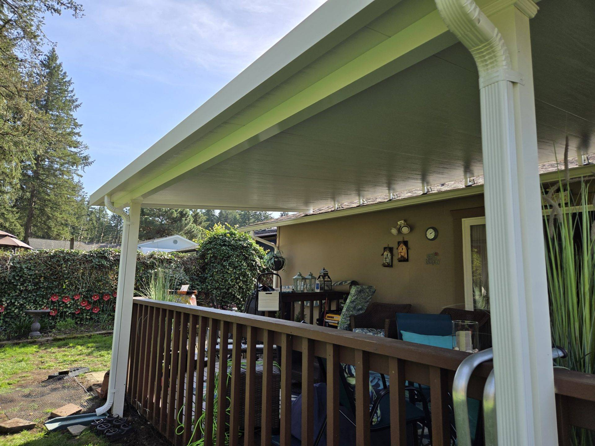 A covered patio featuring a porch and a deck, providing a cozy outdoor space for relaxation and gatherings.