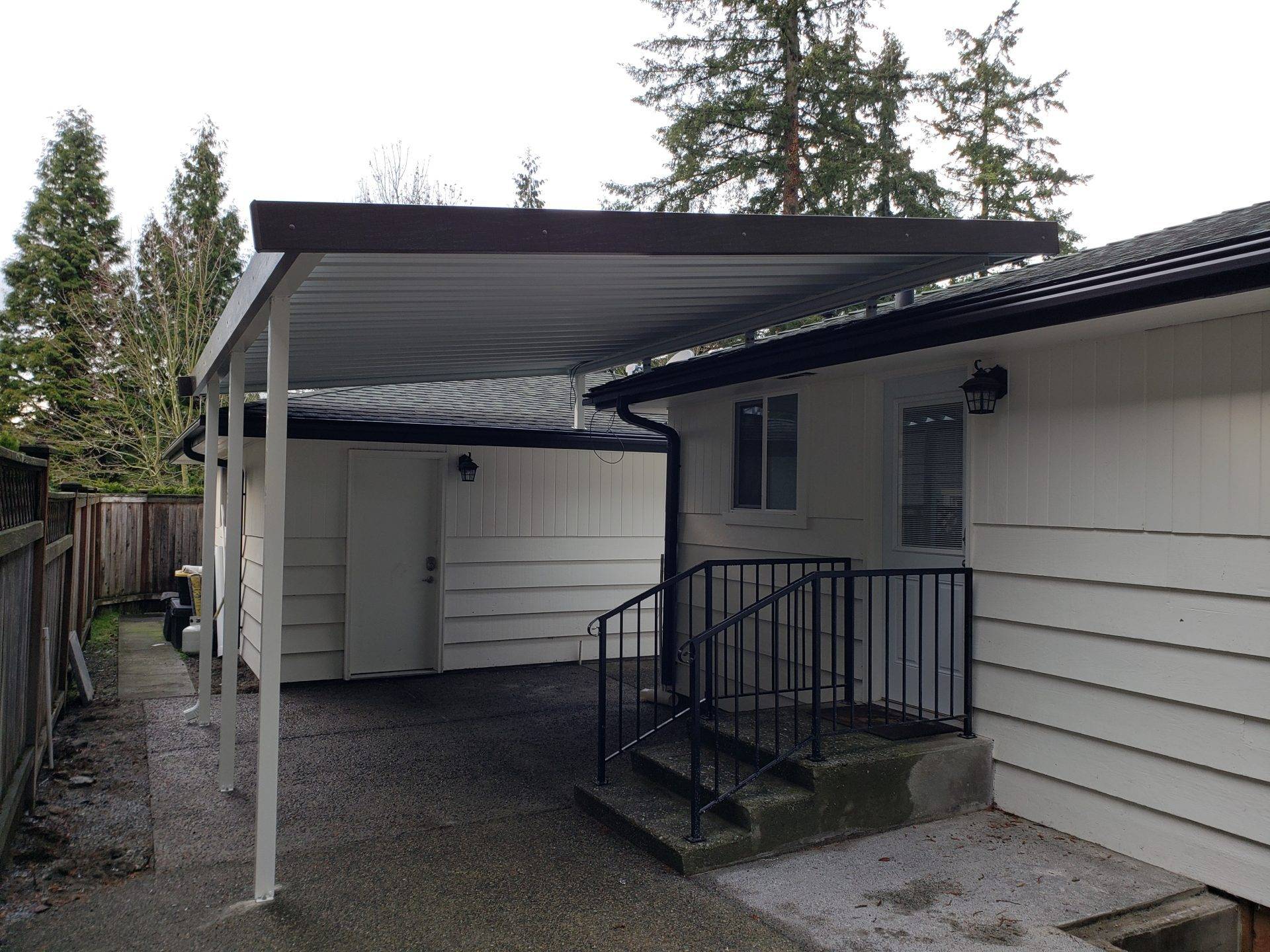 A house featuring a covered patio and a set of stairs leading to the entrance.